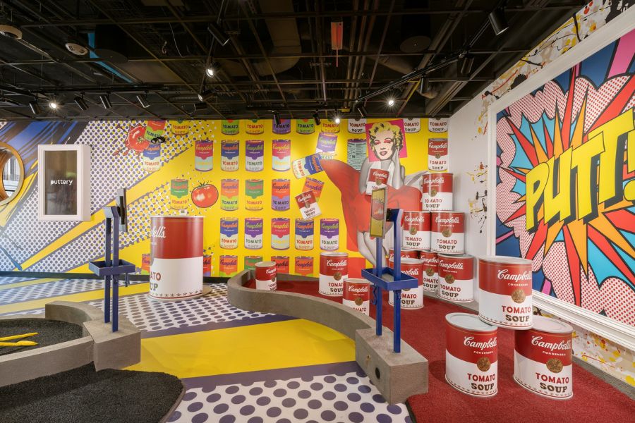 Pop art-themed mini golf course with Campbell’s Soup cans and comic-style decor at Puttery.