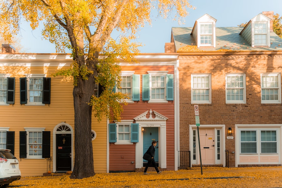 Person walking through Georgetown during Fall season 