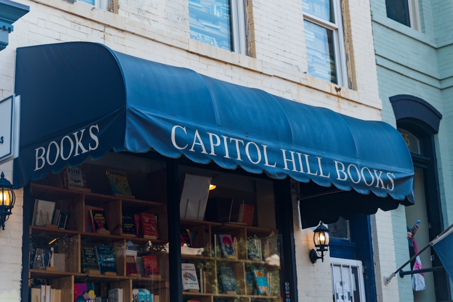 The awning of a quaint bookstore that reads, "Capitol Hill Books."