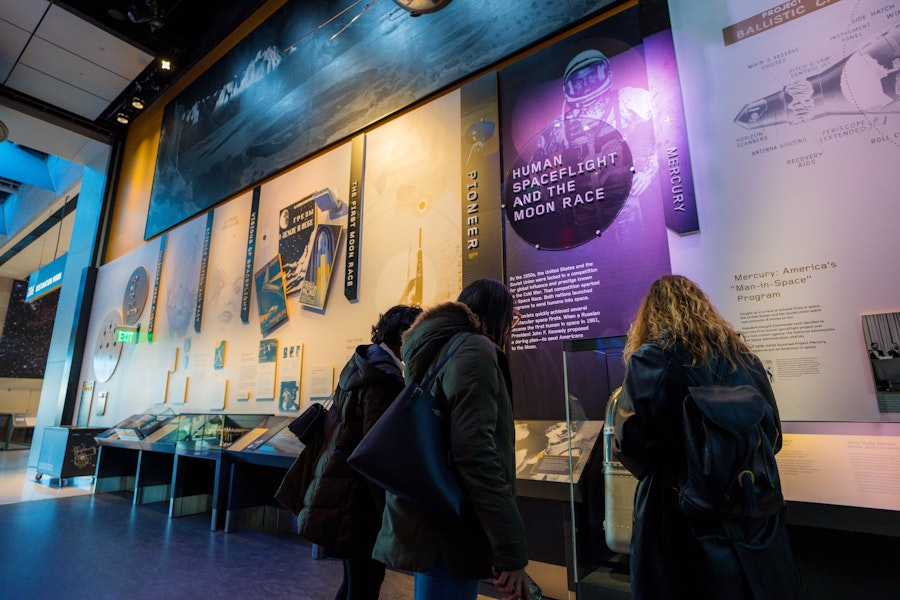 Visitors read exhibits on the history of human spaceflight and the moon race.