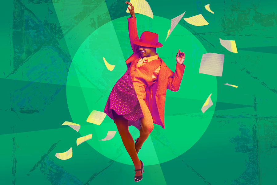 A joyful actor in period costumes dances energetically on stage.