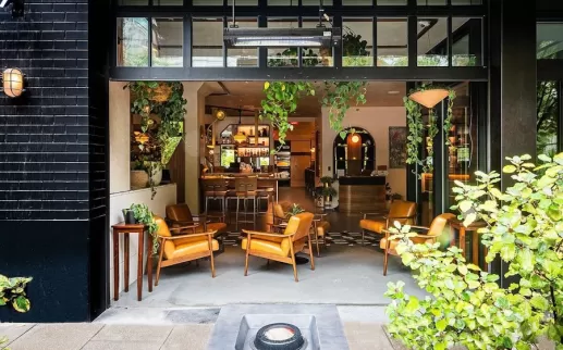 indoor/outdoor patio space with plants, chic outdoor furniture, and a fire pit at Eaton DC