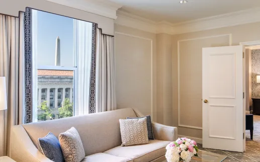 An elegant hotel room with a view of the Washington Monument. 